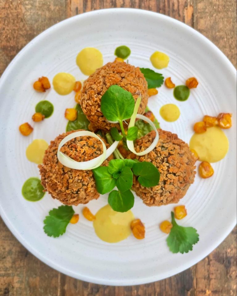 Gourmet vegetable dish with citrus garnish