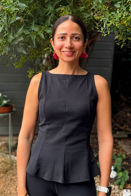 Tania smiling at an outdoor dining setting